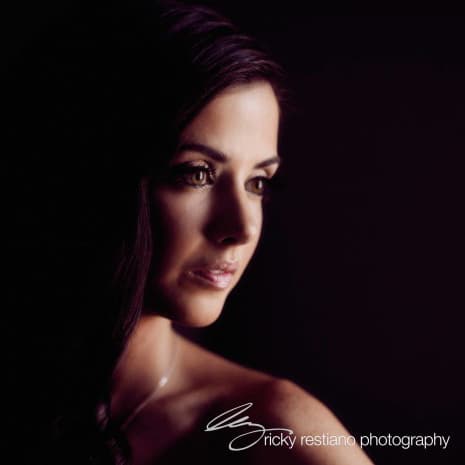 A bride in soft dramatic makeup, side profile