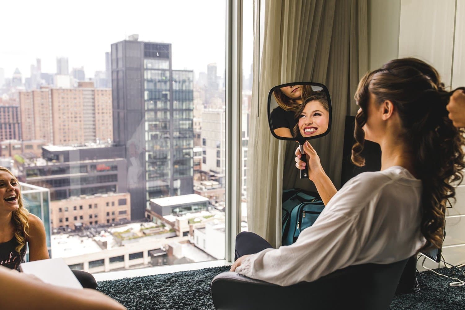 A client checking her makeup in a hand mirror