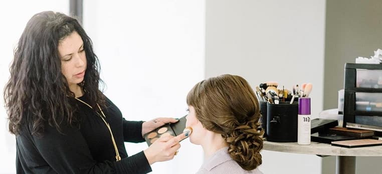 Meredith brushing foundation onto a workshop guest